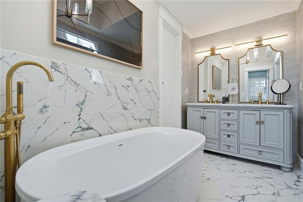Freestanding tub, double vanity and gray vanity at 206 NE Shoreview Drive, Lee's Summit, MO 64064