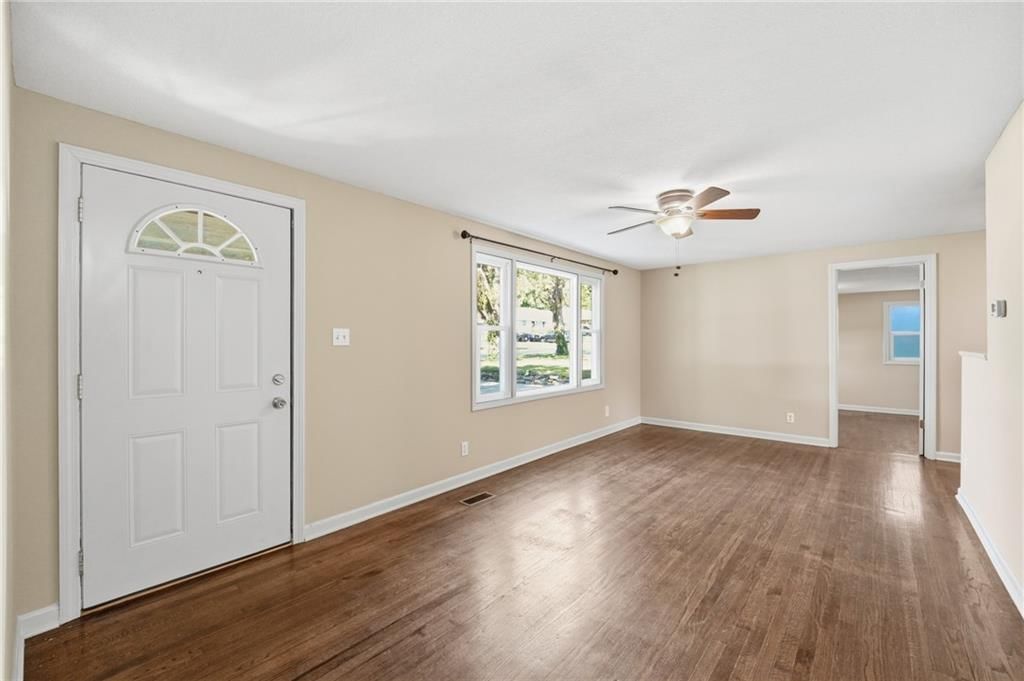 Main-floor primary bedroom and hardwood floors at 7049 Horton Street, Overland Park, KS 66204