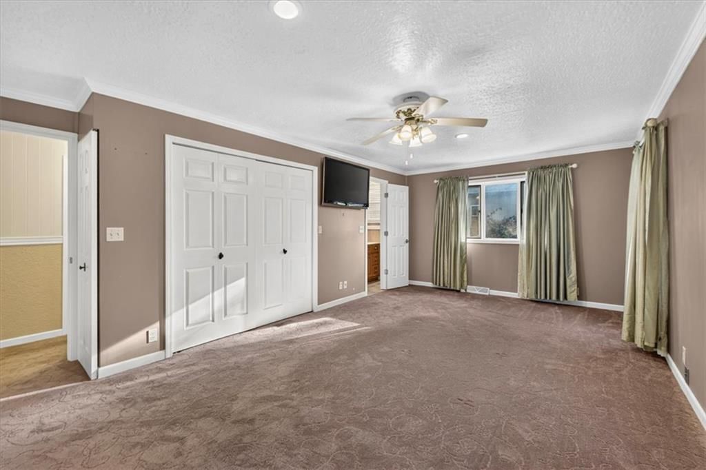 Main-floor primary bedroom at 340 Champ Street, Peculiar, MO 64078