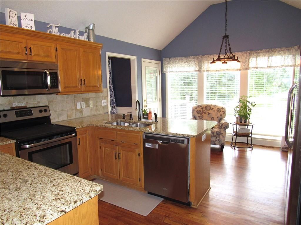 Kitchen island, granite counters and breakfast nook at 21024 W 116th Terrace, Olathe, KS 66061