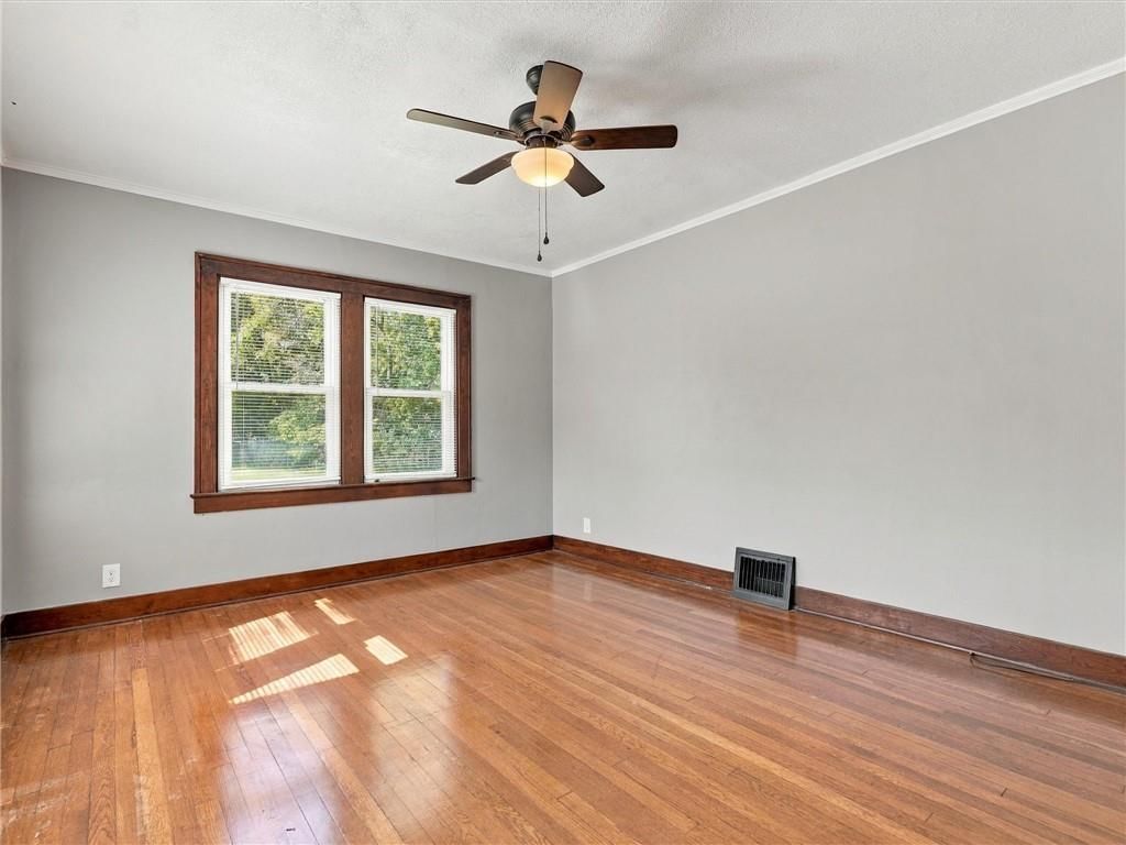 Main-floor primary bedroom, hardwood floors and black hardware at 51 N Emerson Street, Kansas City, MO 64119