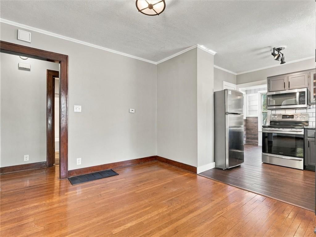Gray kitchen cabinets, stainless steel appliances and updated kitchen at 51 N Emerson Street, Kansas City, MO 64119