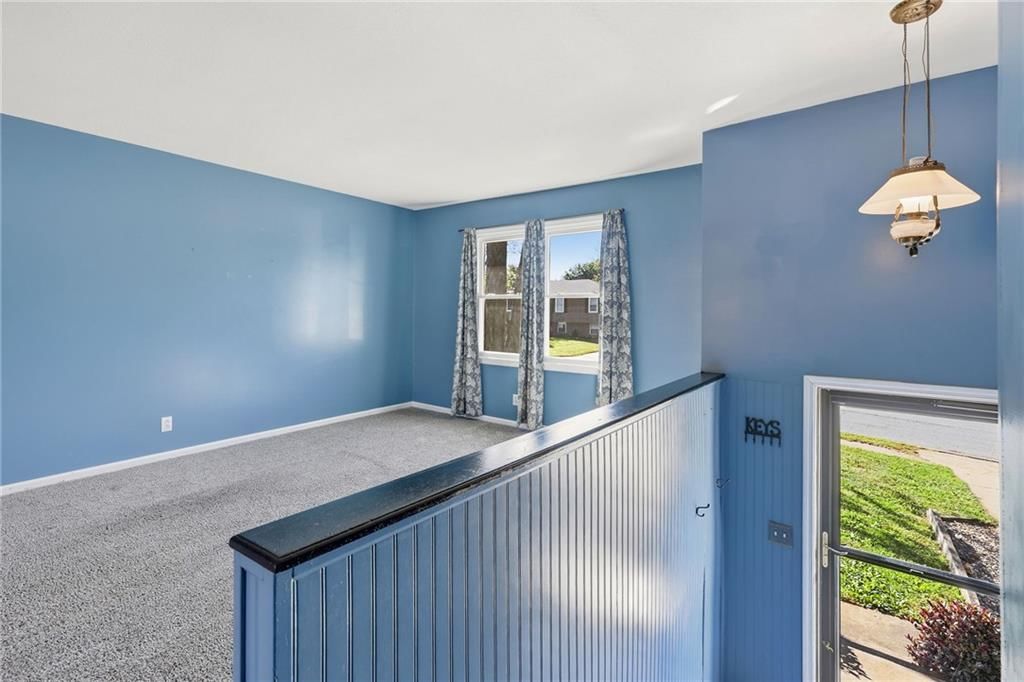 Staircase and blue main wall color at 1505 Eastwood Road, Harrisonville, MO 64701