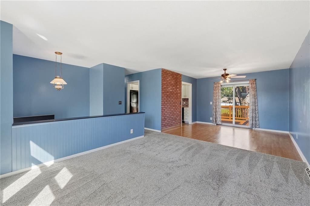 Open floor plan and exposed brick wall at 1505 Eastwood Road, Harrisonville, MO 64701