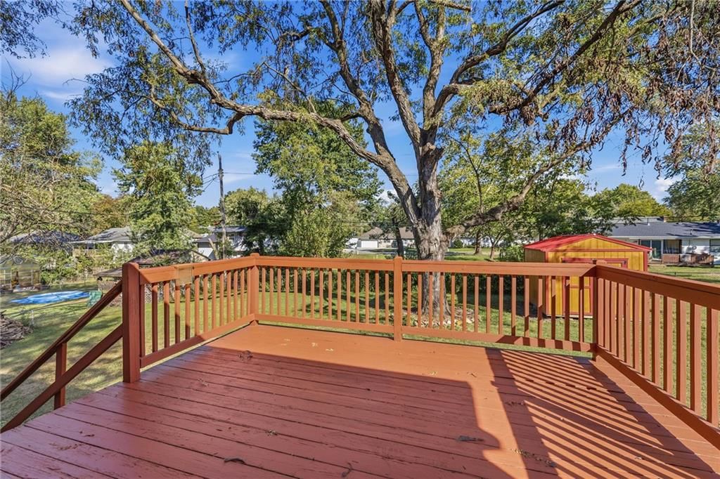 Deck, big backyard and fenced yard at 1505 Eastwood Road, Harrisonville, MO 64701