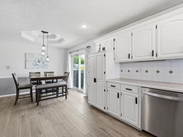 Open floor plan, white kitchen and breakfast nook at 713 NW Rosaceae Drive, Blue Springs, MO 64015