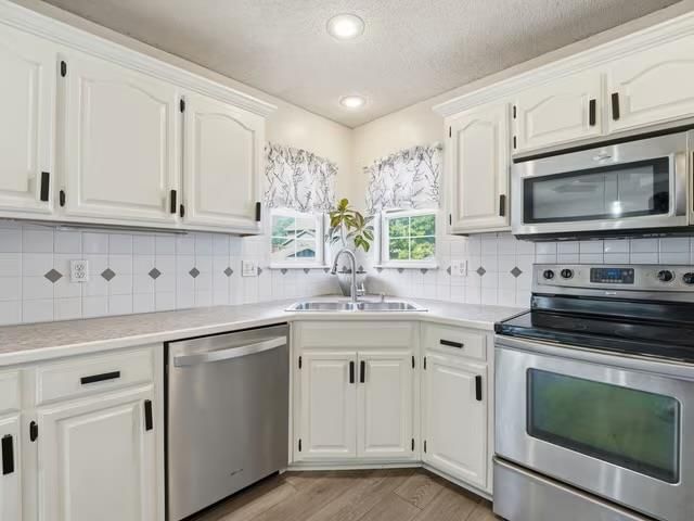 Stainless steel appliances and electric range at 713 NW Rosaceae Drive, Blue Springs, MO 64015