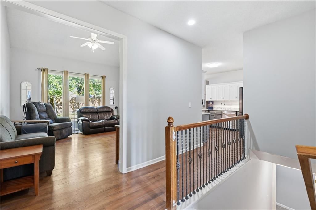 Hardwood floors, staircase and iron stair railing at 20426 W 220th Terrace, Spring Hill, KS 66083