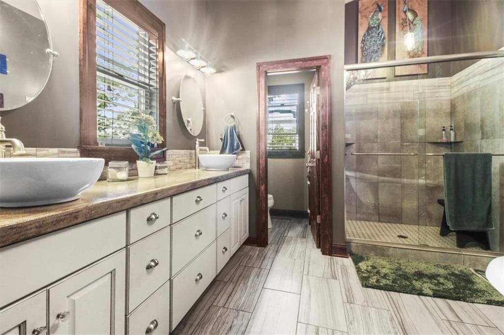 Walk-in shower, tiled shower and double vanity at 1608 Smith Street, Blue Springs, MO 64015