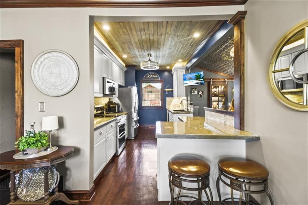 Kitchen island, statement lighting and two-tone kitchen cabinets at 1608 Smith Street, Blue Springs, MO 64015