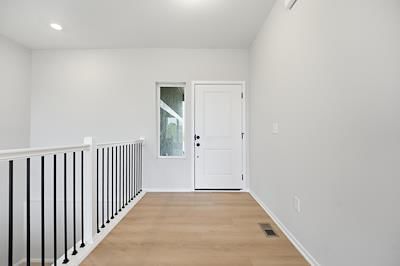 Staircase, iron stair railing and black hardware at 1600 SW 9th Street, Oak Grove, MO 64075
