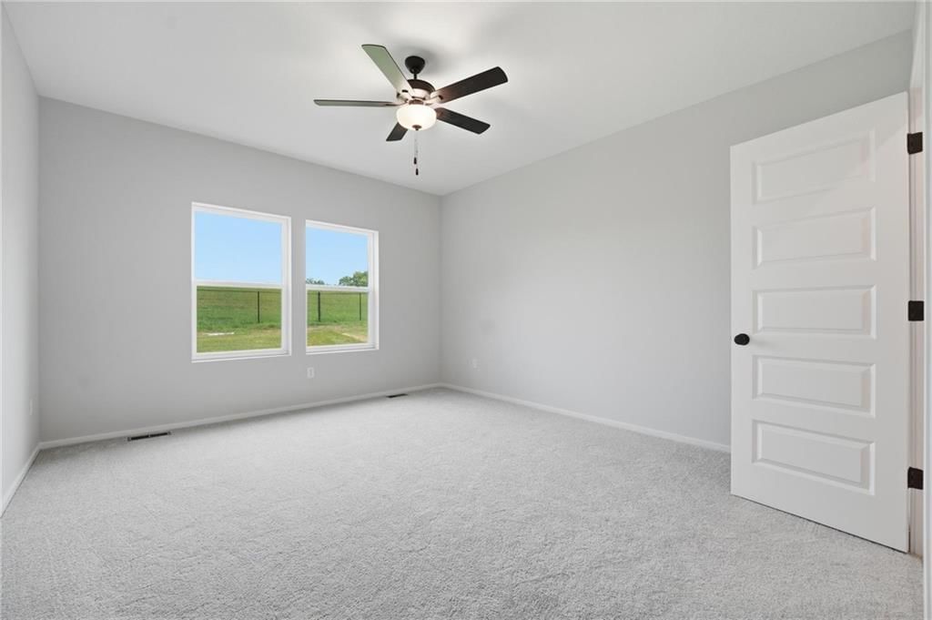 Main-floor primary bedroom and carpet at 1600 SW 9th Street, Oak Grove, MO 64075