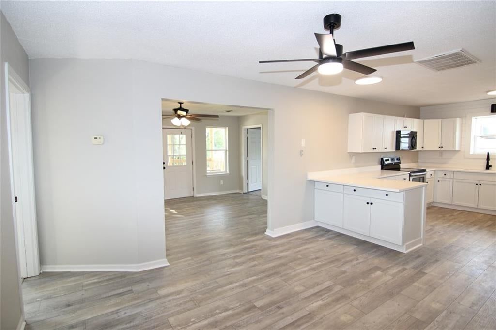 Open floor plan, white kitchen and shaker cabinets at 5638 Miami Avenue, Kansas City, KS 66106