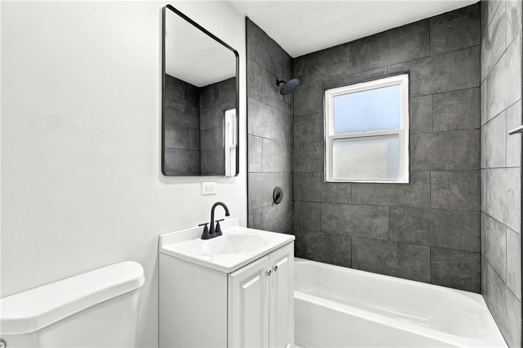 Tiled shower and renovated bathrooms at 4411 Springfield Street, Kansas City, KS 66103