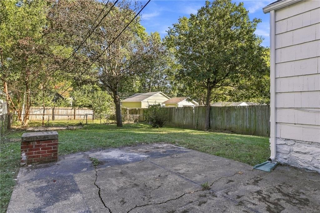 Fenced yard, concrete patio and flat lot at 4411 Springfield Street, Kansas City, KS 66103
