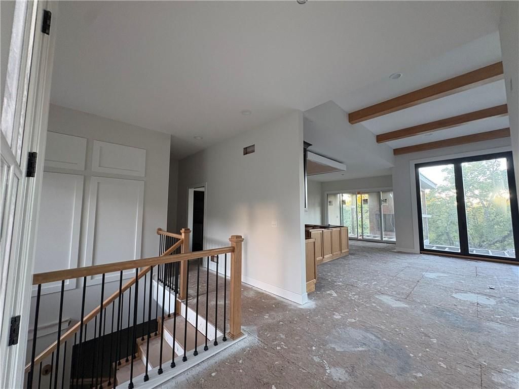 Staircase, iron stair railing and white trim at 121 Teton Ridge, Lake Winnebago, MO 64034