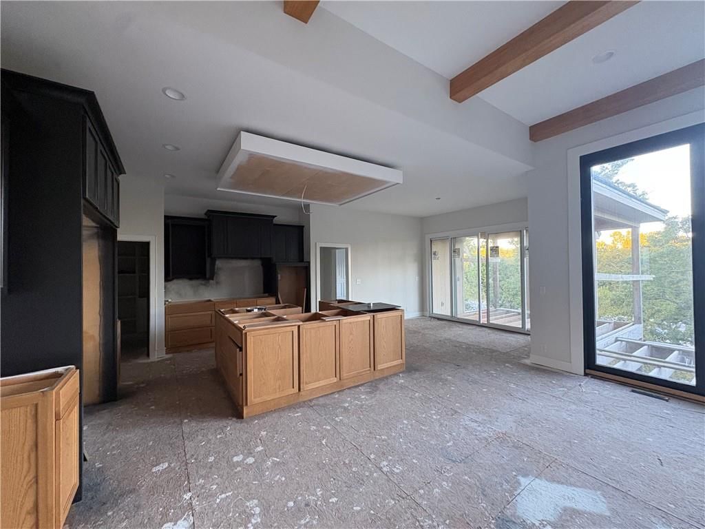 Tall ceilings, open floor plan and kitchen island at 121 Teton Ridge, Lake Winnebago, MO 64034