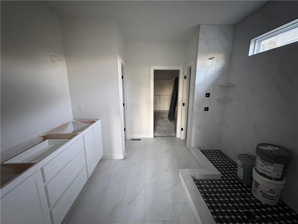 Walk-in shower, tiled shower and double vanity at 121 Teton Ridge, Lake Winnebago, MO 64034