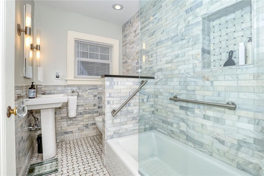 Tiled shower, frameless glass shower and renovated bathrooms at 1600 W 51st Street, Kansas City, MO 64112