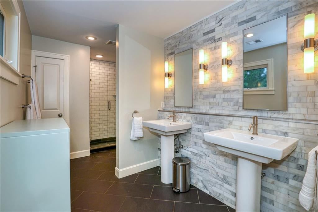 Walk-in shower, double vanity and white vanity at 1600 W 51st Street, Kansas City, MO 64112