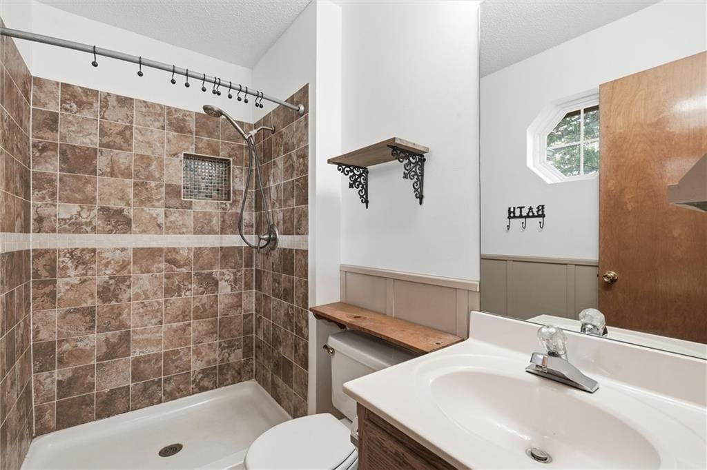 Tiled shower at 1302 Deena Street, Pleasant Hill, MO 64080