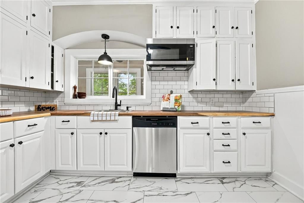 White kitchen, tile floors and stainless steel appliances at 720 W 7th Street, Leavenworth, KS 66048
