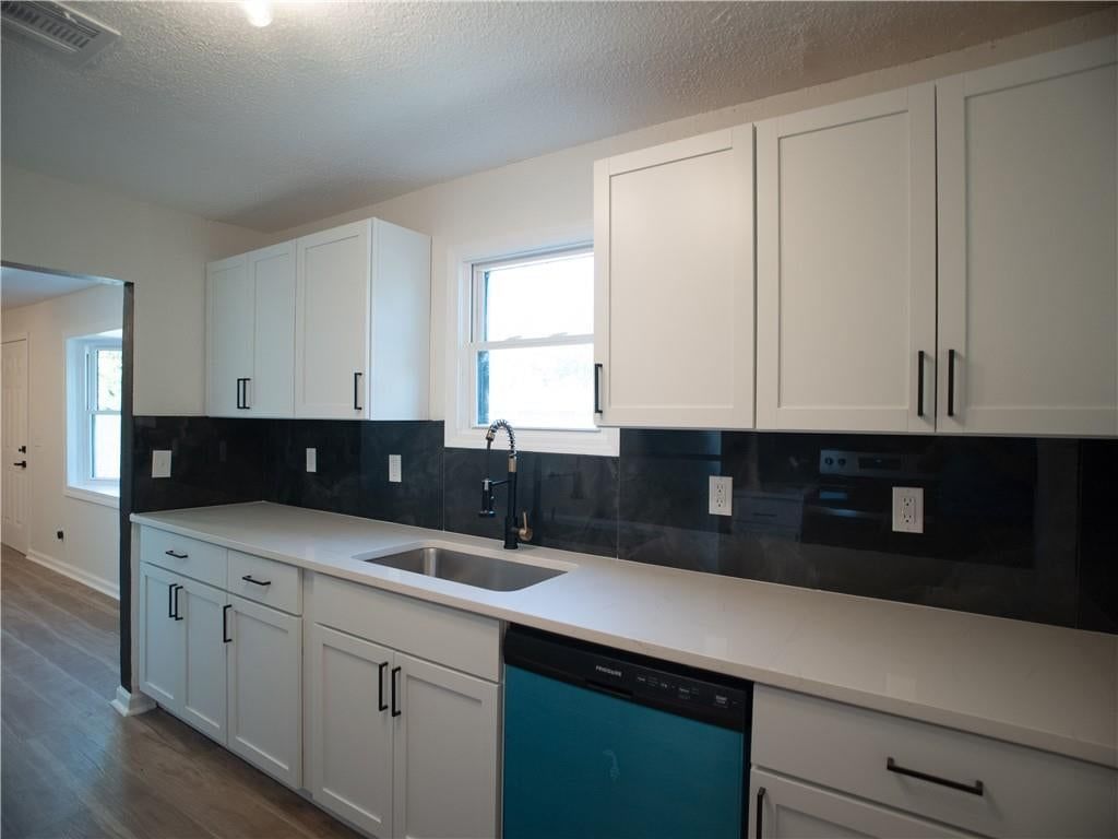 White kitchen, updated kitchen and kitchen backsplash at 3201 Hagemann Street, Kansas City, KS 66106
