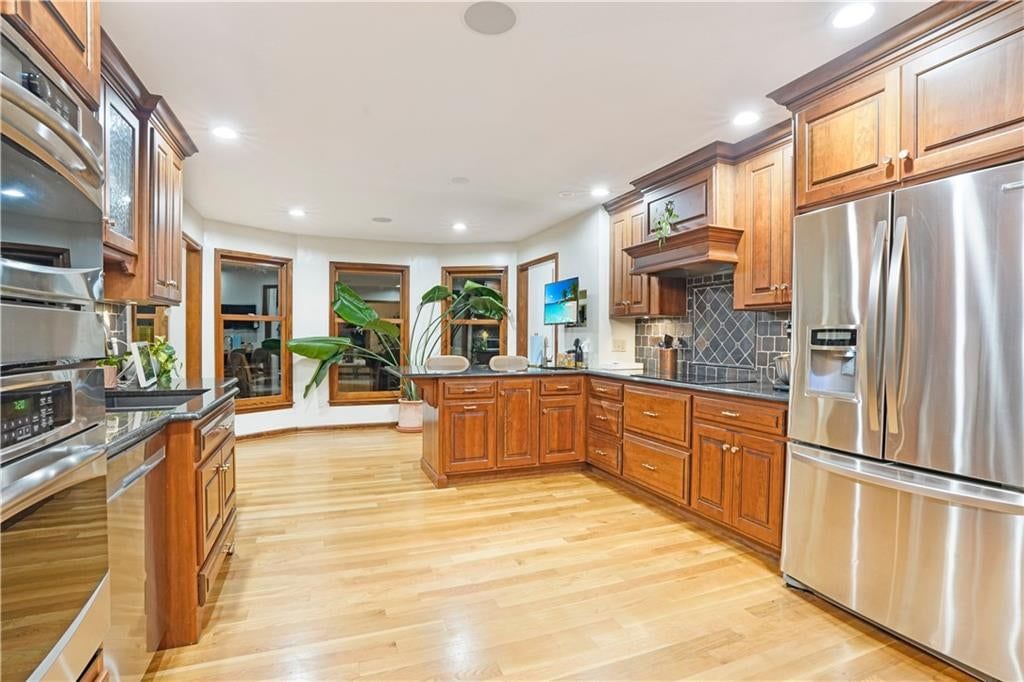 Kitchen island and wall of windows at 7955 NW Bridle Parc Lane, Kansas City, MO 64152