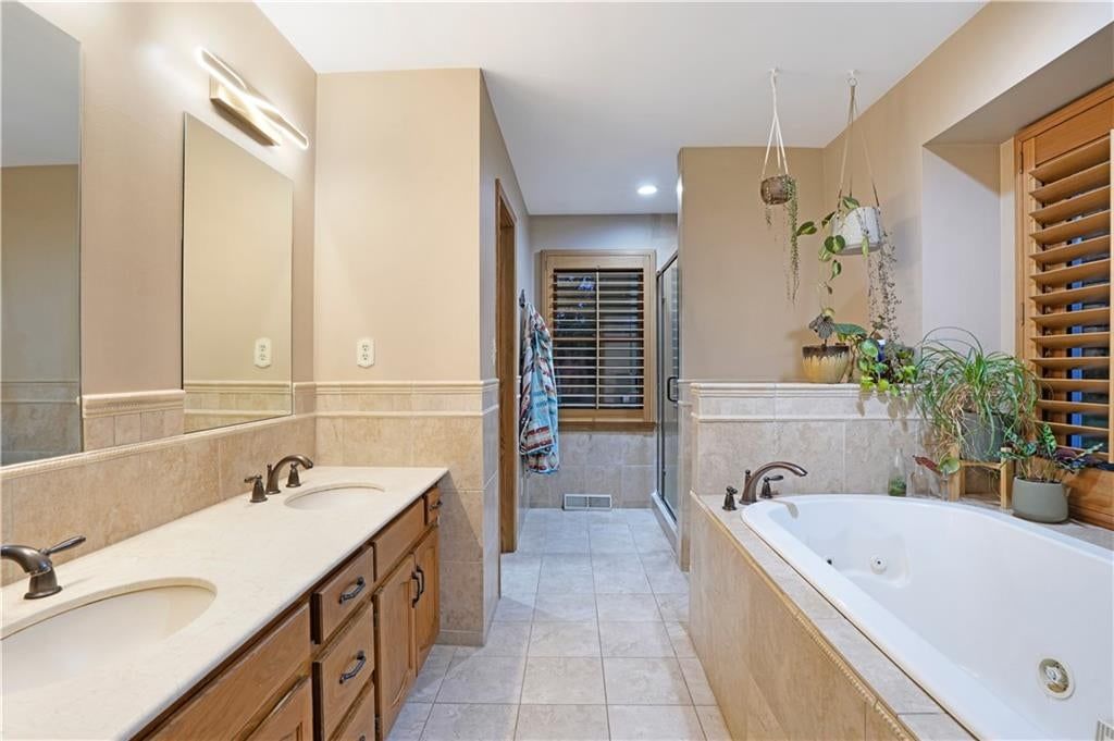 Walk-in shower and double vanity at 7955 NW Bridle Parc Lane, Kansas City, MO 64152