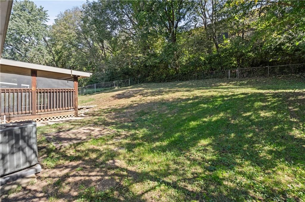 Fenced yard, mature trees and flat lot at 413 Maple Street, Liberty, MO 64068