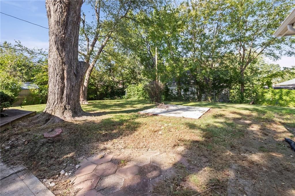 Mature trees and flat lot at 6912 N Harrison Street, Gladstone, MO 64118