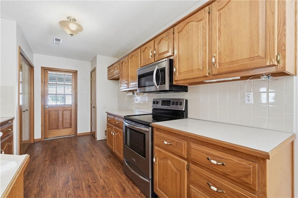 Stainless steel appliances and electric range at 502 S Saturn Drive, Raymore, MO 64083
