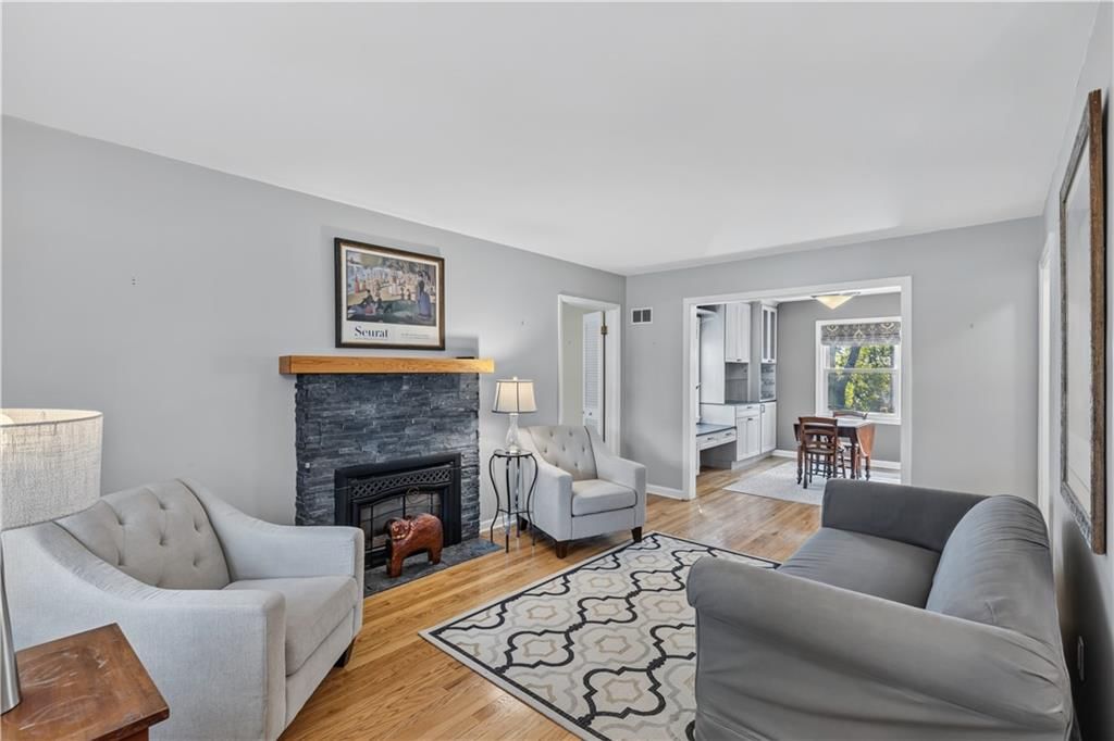 Fireplace, hardwood floors and staircase at 635 E 65th Street, Kansas City, MO 64131