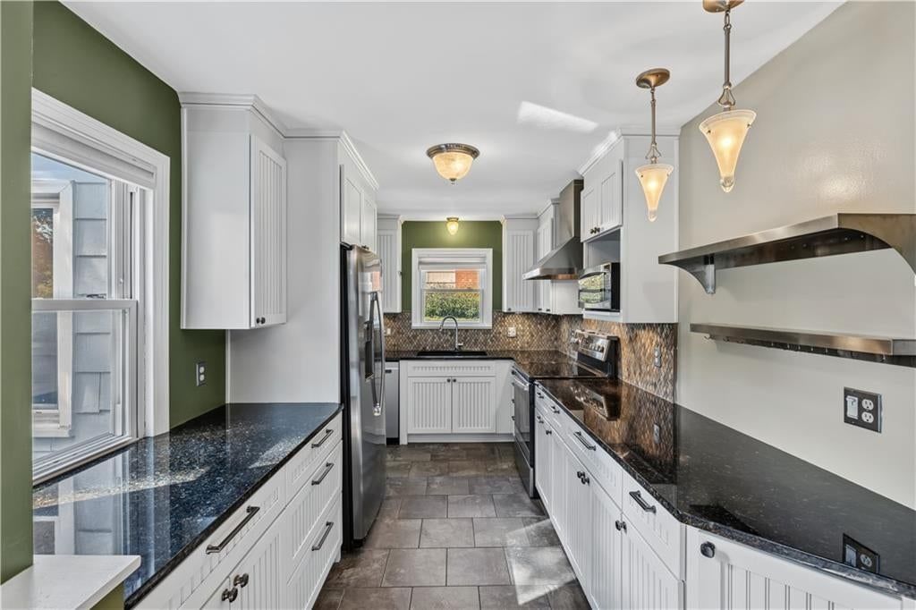 White kitchen, stainless steel appliances and updated kitchen at 635 E 65th Street, Kansas City, MO 64131