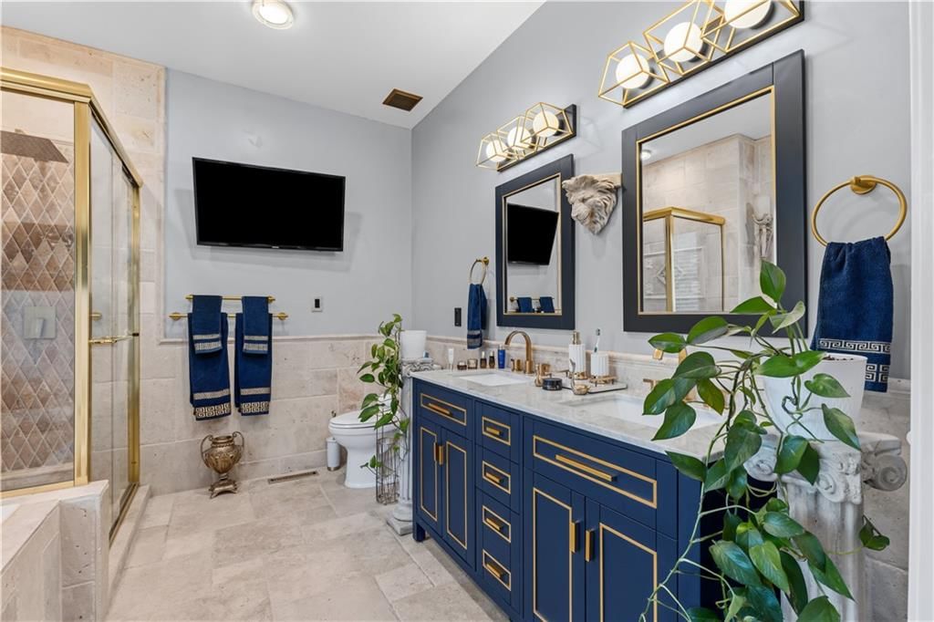 Walk-in shower, tiled shower and double vanity at 7407 Marion Avenue, Kansas City, MO 64133
