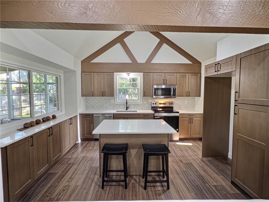 Kitchen island, quartz counters and stainless steel appliances at 8809 Widmer Road, Lenexa, KS 66215