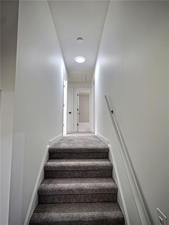 Staircase and wood stair railing at 8809 Widmer Road, Lenexa, KS 66215