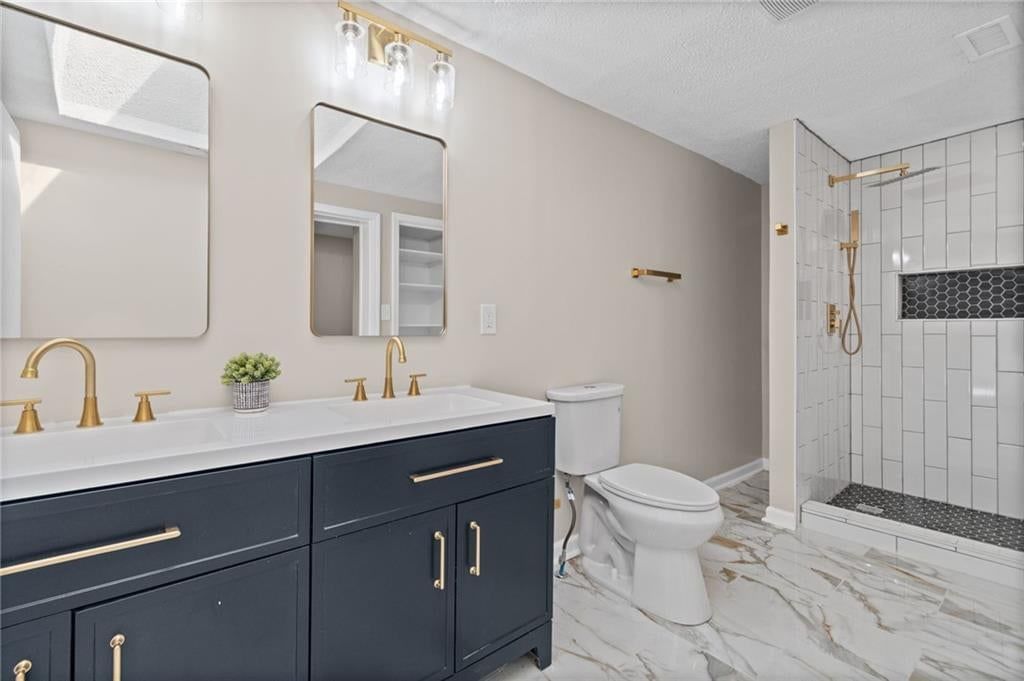 Walk-in shower, tiled shower and double vanity at 3101 56th Terrace, Kansas City, MO 64119