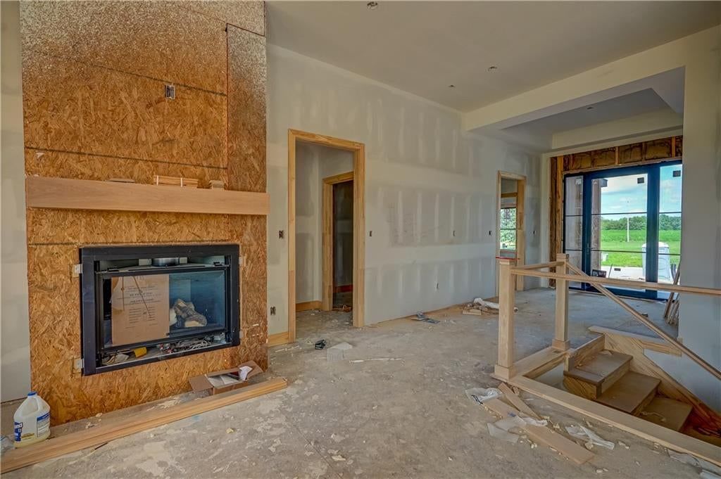 Fireplace and staircase at 13 Red Fox Circle, Lake Winnebago, MO 64034
