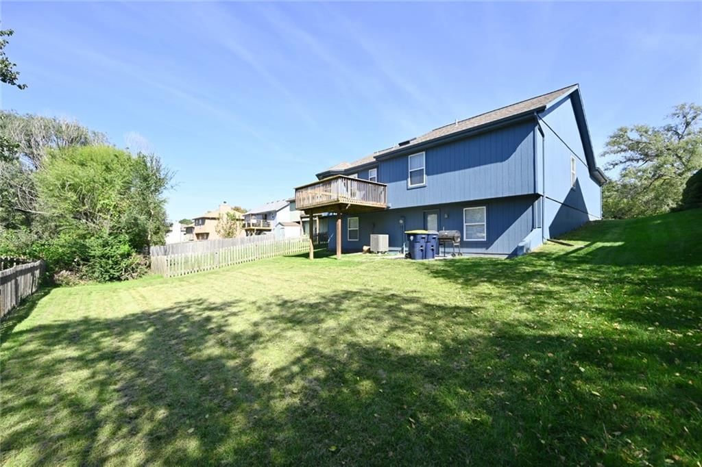 Fenced yard and mature trees at 11304 N NASHUA Drive, Kansas City, MO 64155