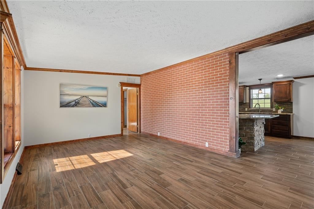 Exposed brick wall and tile floors at 25160 W 223rd Street, Spring Hill, KS 66083