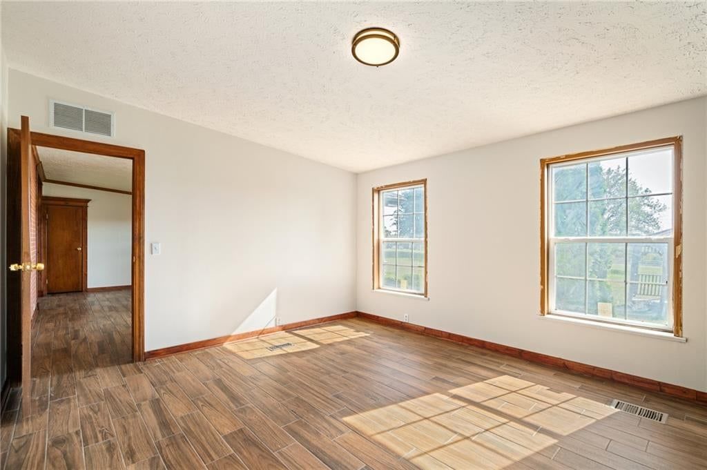 Main-floor primary bedroom, walk-in shower and tiled shower at 25160 W 223rd Street, Spring Hill, KS 66083