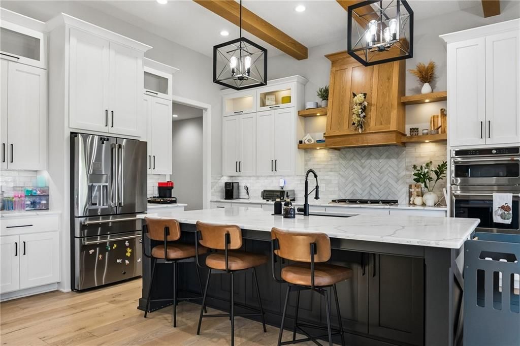 Kitchen island, white kitchen and quartz counters at 12804 NE 117th Street, Kearney, MO 64060