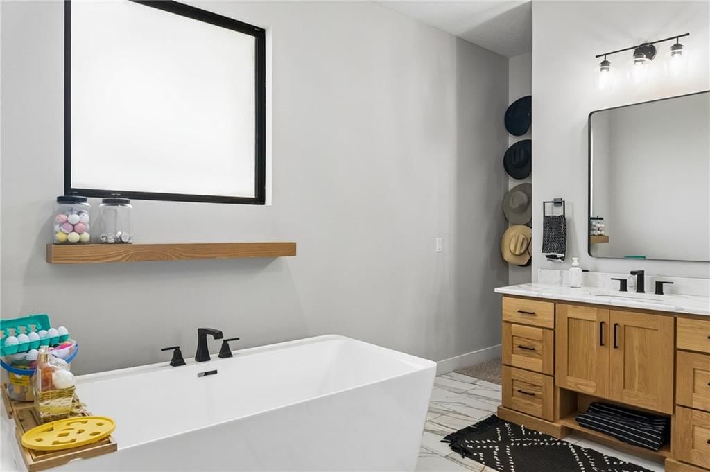 Freestanding tub, wood vanity and renovated bathrooms at 12804 NE 117th Street, Kearney, MO 64060