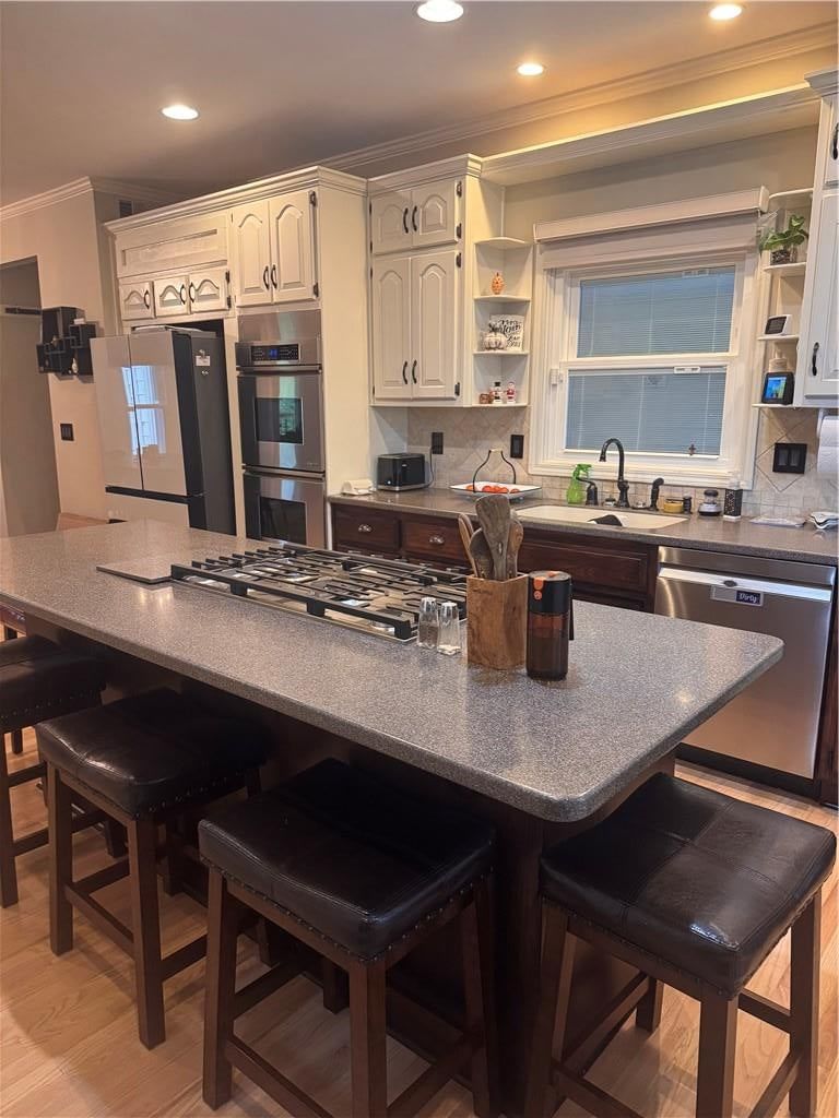 Kitchen island, hardwood floors and white kitchen at 11505 Easley Drive, Lee's Summit, MO 64086