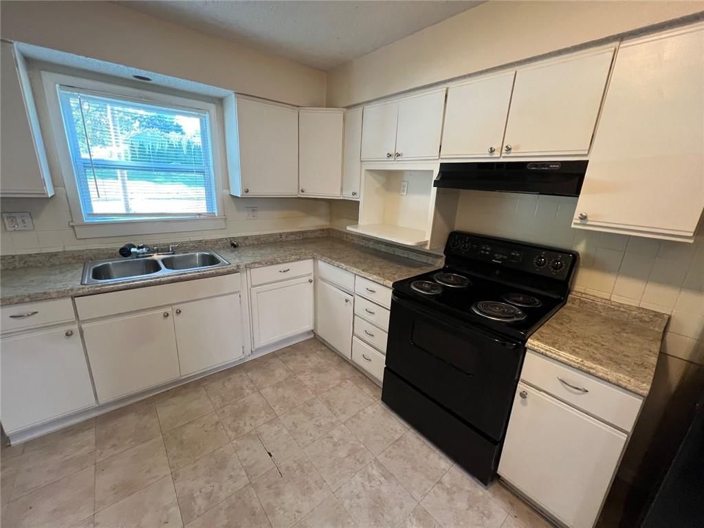 White kitchen and tile floors at 3406 E 73RD Street, Kansas City, MO 64132