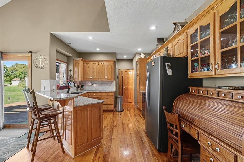 Black appliances and glass-front cabinets at 14891 142nd Street, Bonner Springs, KS 66012
