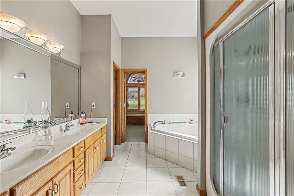 Tile floors, walk-in shower and tiled shower at 14891 142nd Street, Bonner Springs, KS 66012