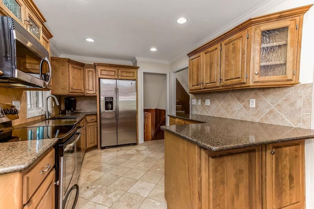 Kitchen island and kitchen backsplash at 7719 Howe Drive, Prairie Village, KS 66062