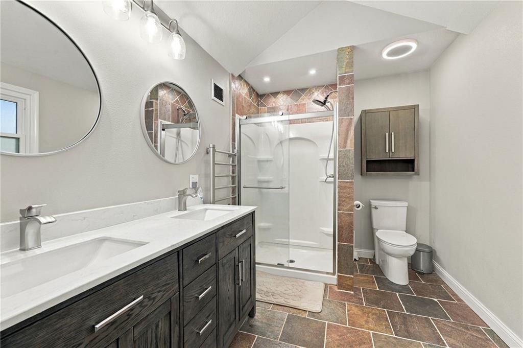 Walk-in shower, tiled shower and double vanity at 9504 NW 87th Terrace, Kansas City, MO 64153